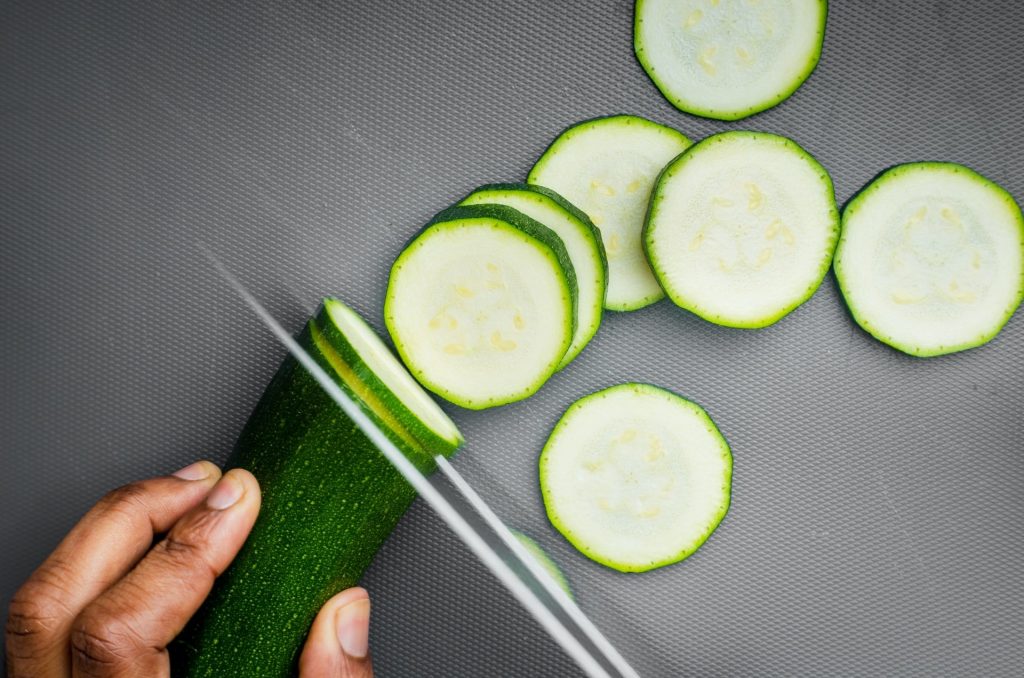 people cutting cucumbers
